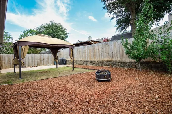 a backyard of a house with barbeque oven