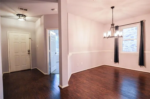 a view of a room with wooden floor and windows