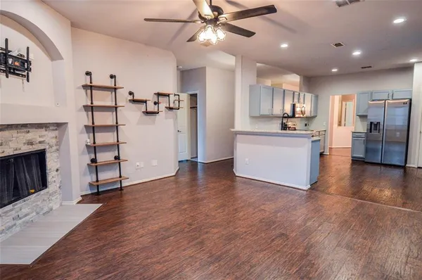 a view of a kitchen with cabinets and wooden floor