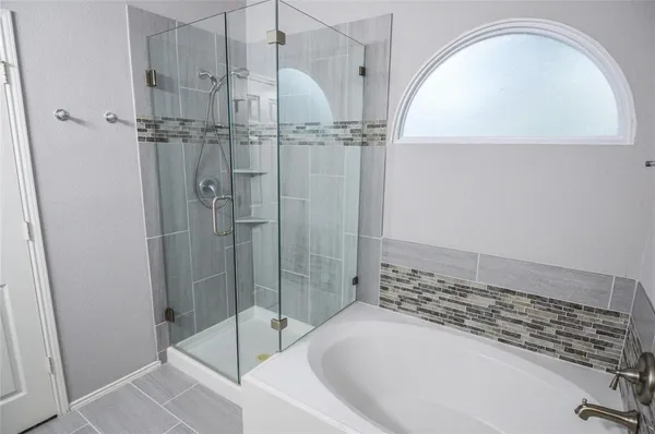 a bathroom with a bathtub and a shower