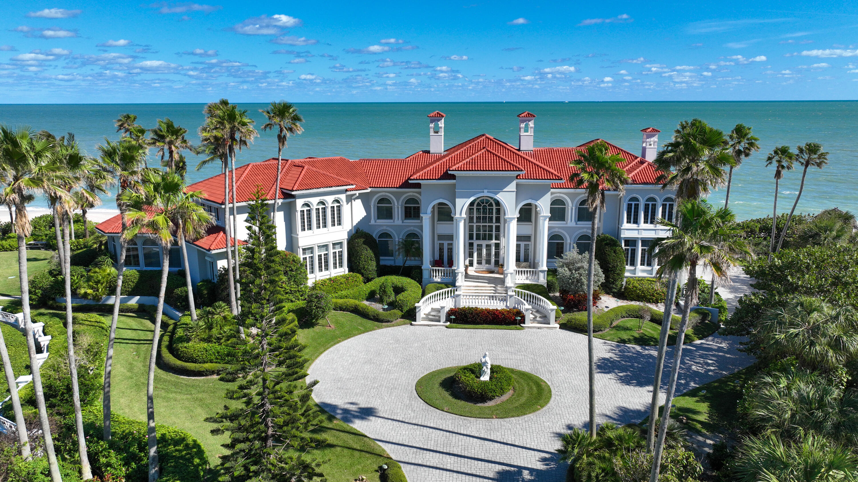a view of a house with pool and chairs