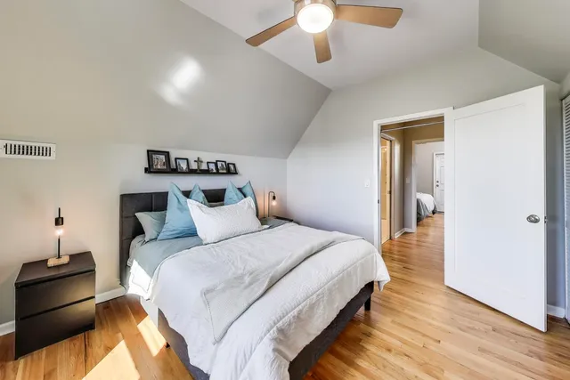 a bedroom with a bed and a chandelier