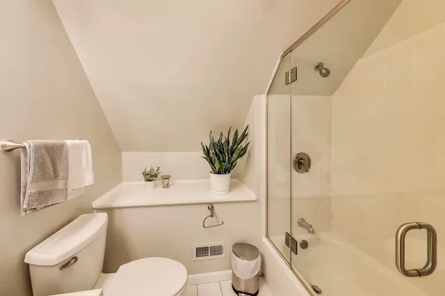 a bathroom with a toilet sink and shower