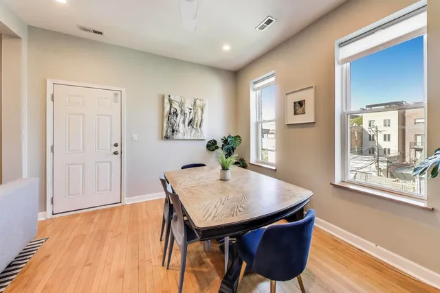 a view of a dining room with furniture and wooden floor