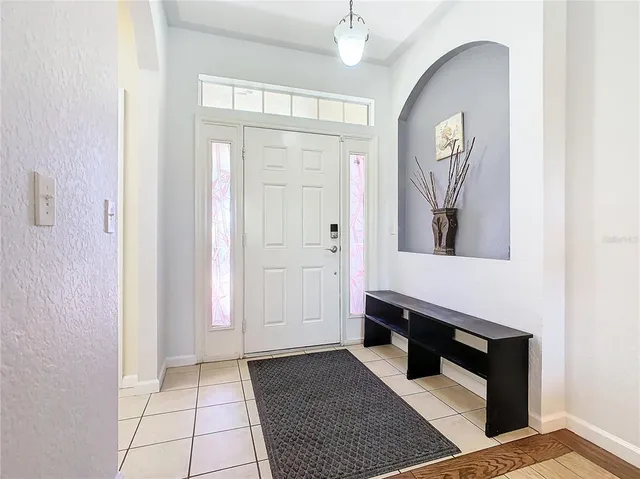 a living room with a baby crib and a dresser