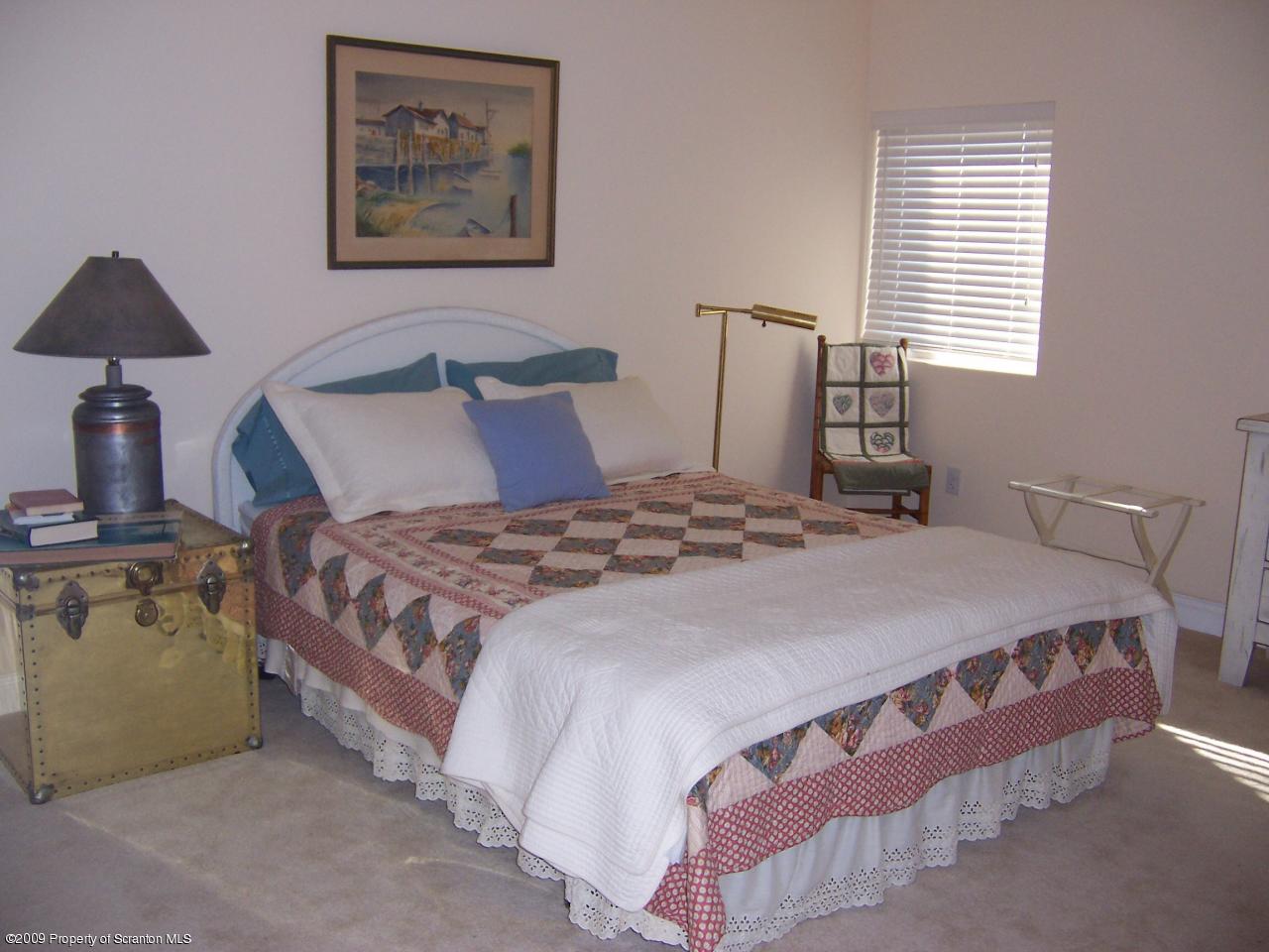 701 Green Ridge Street Scranton, PA 18509 - Photo 8 of 10 a bedroom with a bed and a night stand