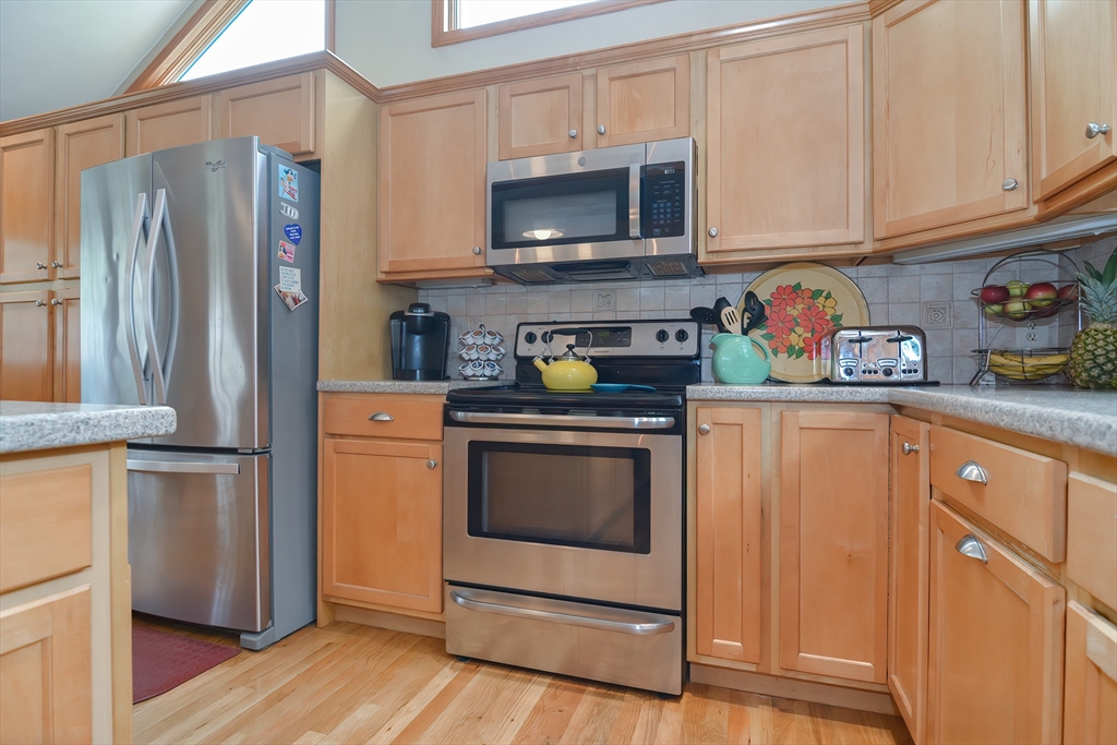 143 South Meadow Road Plymouth, MA 02360 - Photo 12 of 35 a kitchen with stainless steel appliances granite countertop a refrigerator stove and sink