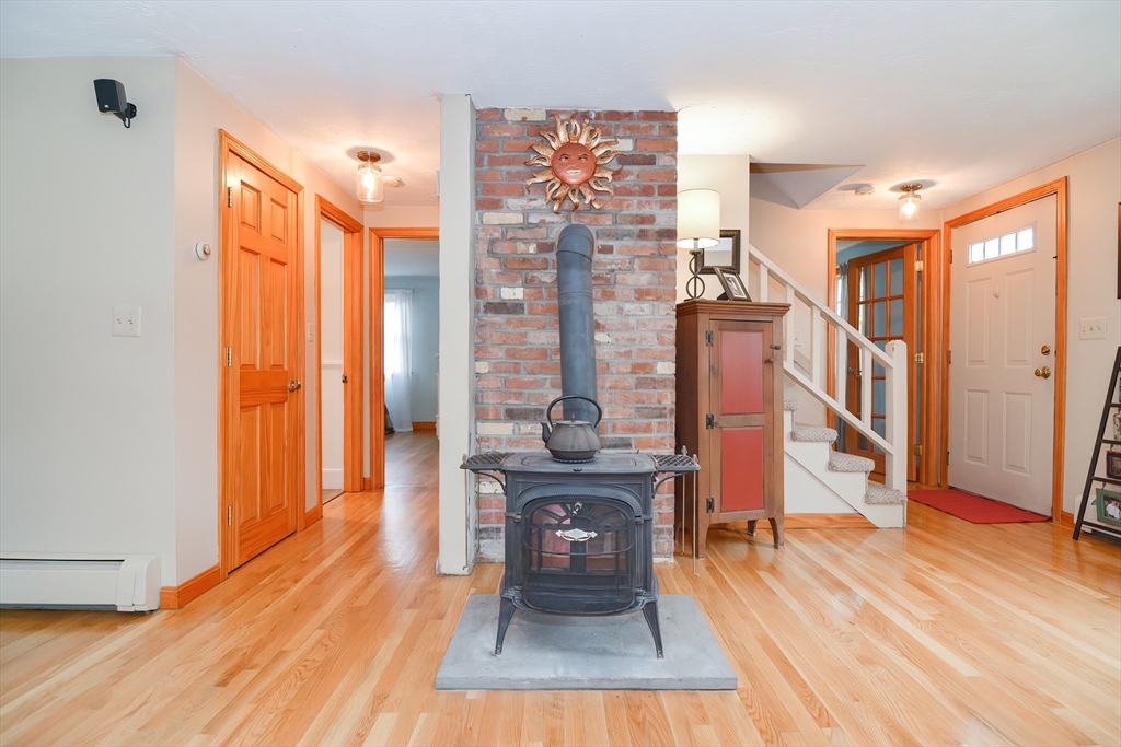 143 South Meadow Road Plymouth, MA 02360 - Photo 15 of 35 a living room with fireplace furniture and a wooden floor