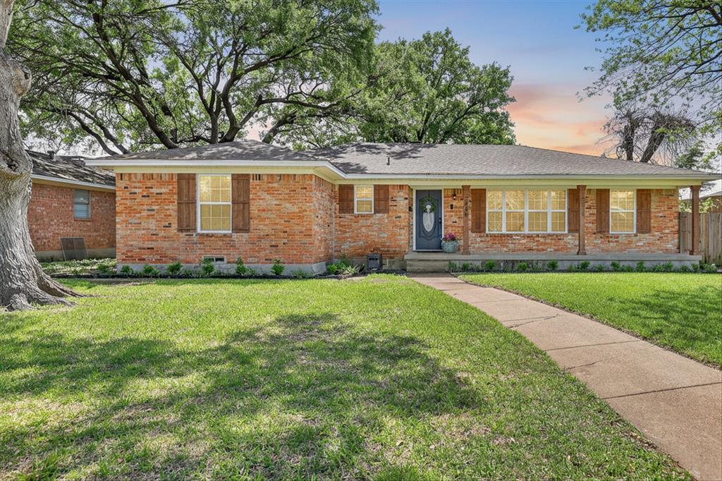 Ranch-style home featuring brick siding and a front lawn