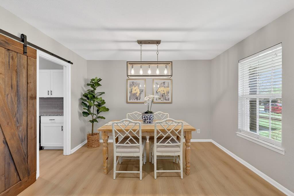 2920 Sharpview Lane Dallas, TX 75228 - Photo 12 of 34 Dining space featuring a barn door and light wood-style flooring