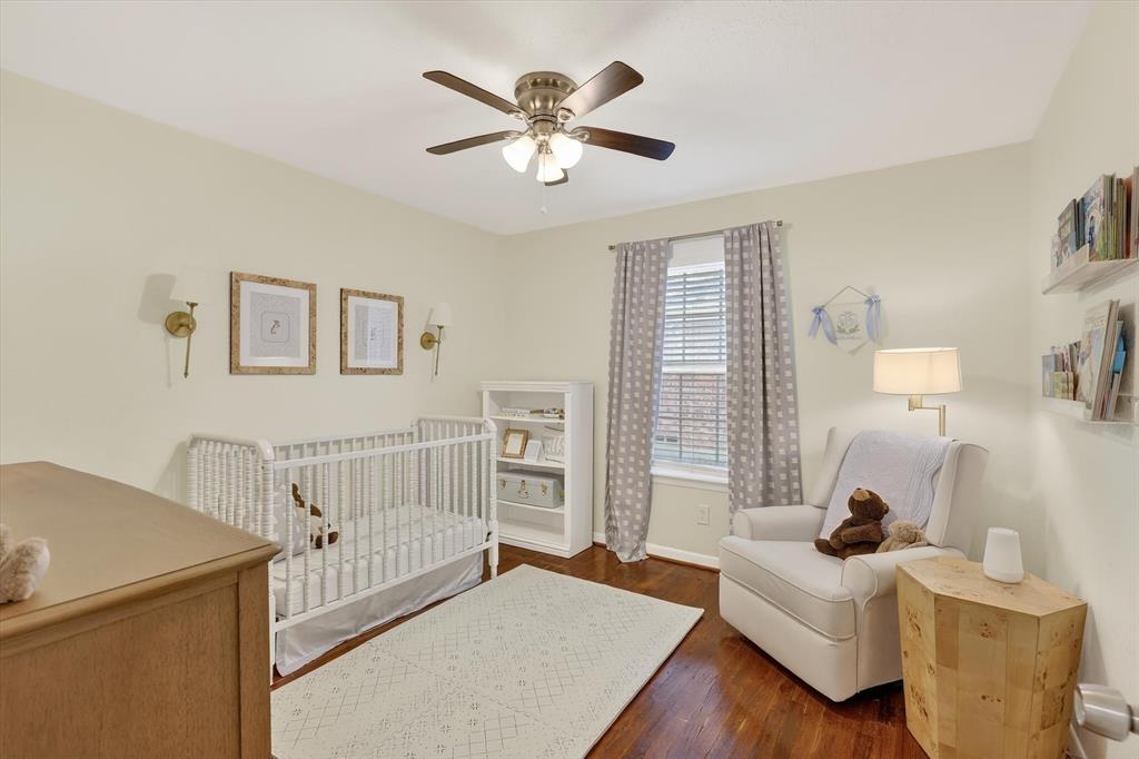 2920 Sharpview Lane Dallas, TX 75228 - Photo 22 of 34 Bedroom with dark wood-type flooring, ceiling fan, and a nursery area