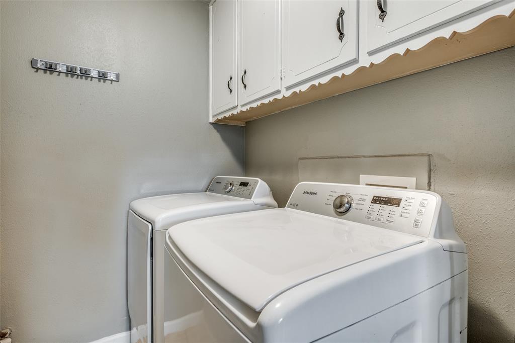 2920 Sharpview Lane Dallas, TX 75228 - Photo 30 of 34 Laundry room with cabinet space and washing machine and clothes dryer