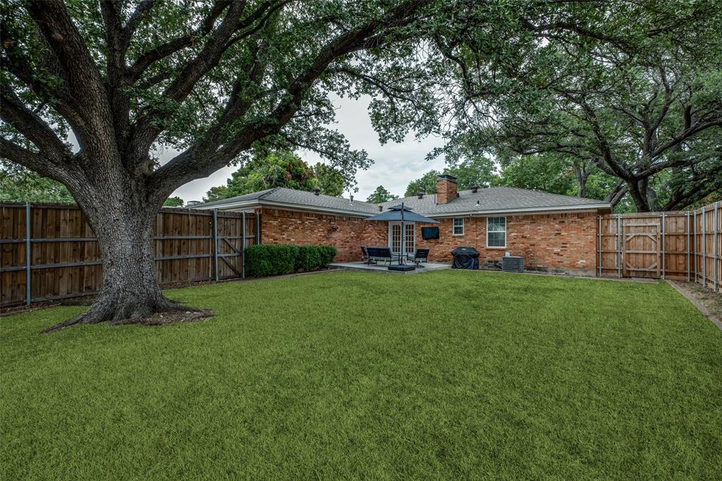 2920 Sharpview Lane Dallas, TX 75228 - Photo 31 of 34 Rear view of house featuring a gate, a patio area, a fenced backyard, brick siding, and a chimney