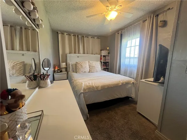 a bedroom with a bed a mirror and furniture
