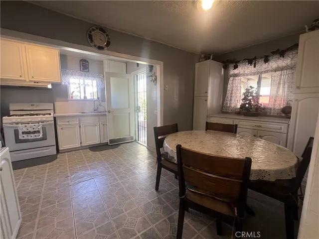 a kitchen with microwave a stove and furniture