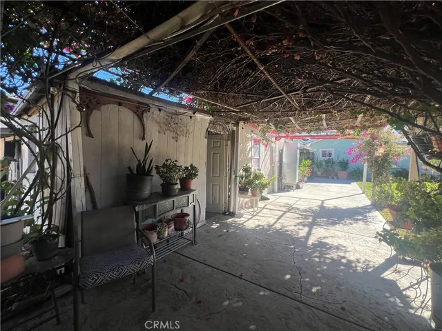 a view of porch with chairs and potted plants