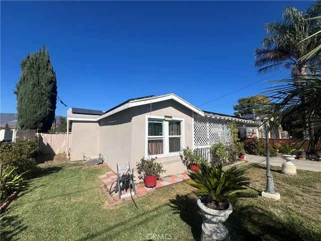 a view of a backyard with plants and a patio