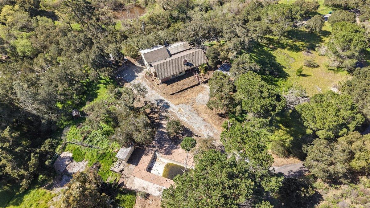 an aerial view of a house with yard and outdoor seating
