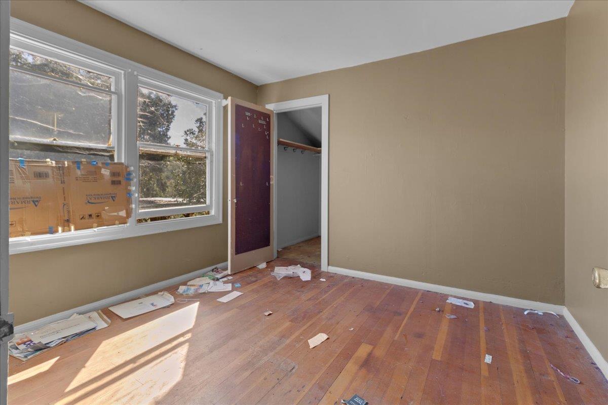 379 Corral De Tierra Road Salinas, CA 93908 - Photo 30 of 47 a view of an empty room with wooden floor and a window