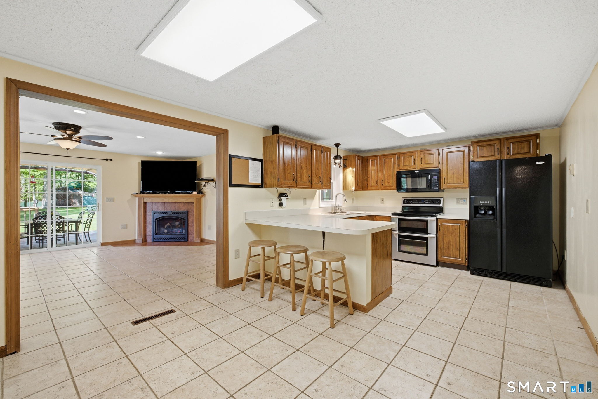 141 Hop River Road Coventry, CT 06238 - Photo 5 of 40 a kitchen with granite countertop a refrigerator and a stove top oven
