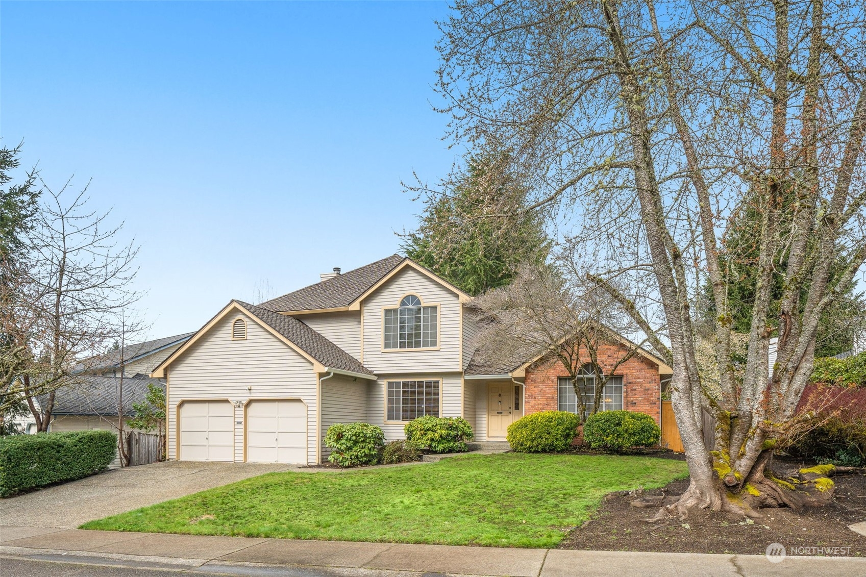 15518 Southeast 183rd Drive Renton, WA 98058 - Photo 1 of 35 a front view of a house with a garden
