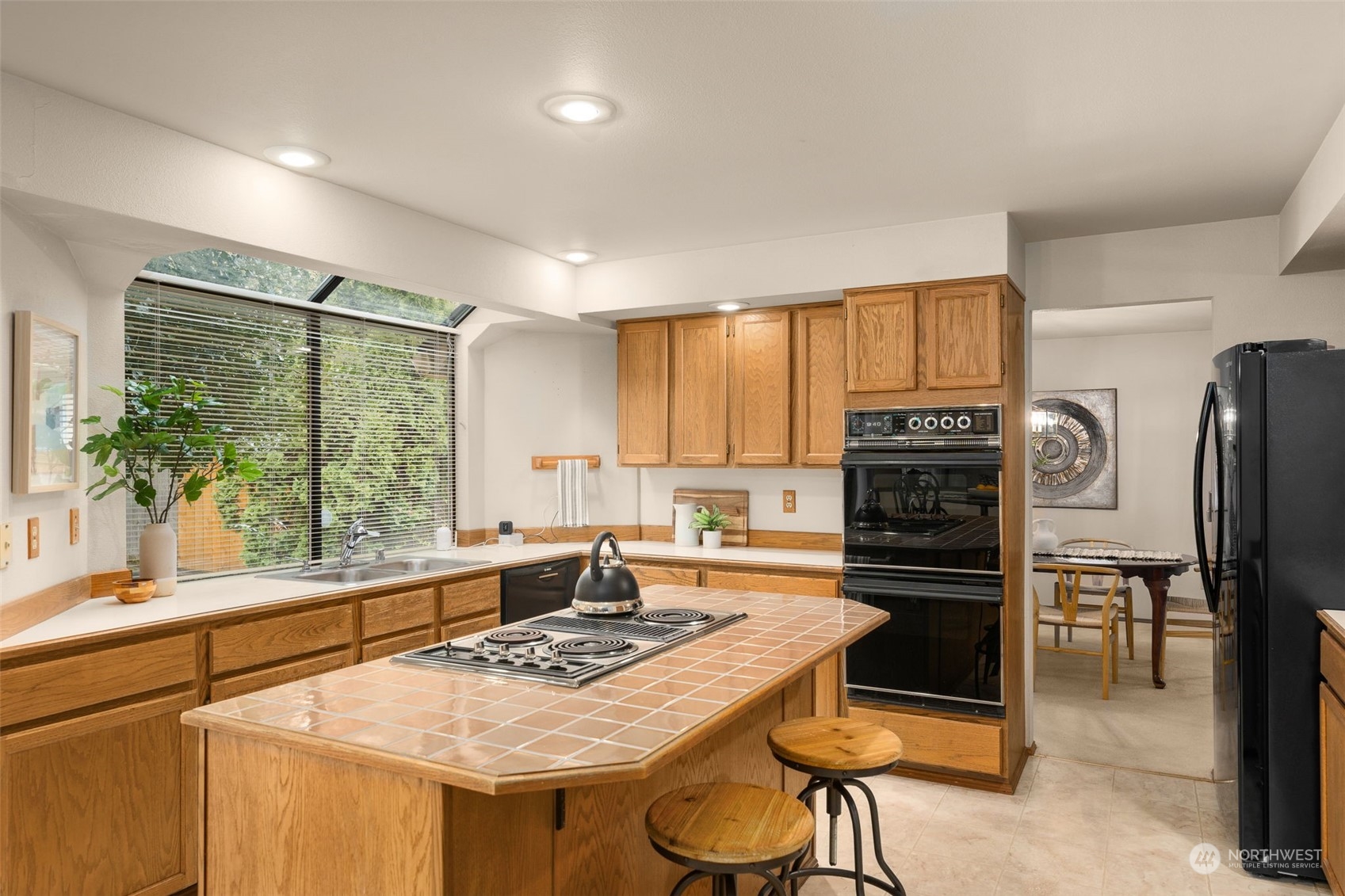 15518 Southeast 183rd Drive Renton, WA 98058 - Photo 12 of 35 a kitchen with a stove a refrigerator and a sink