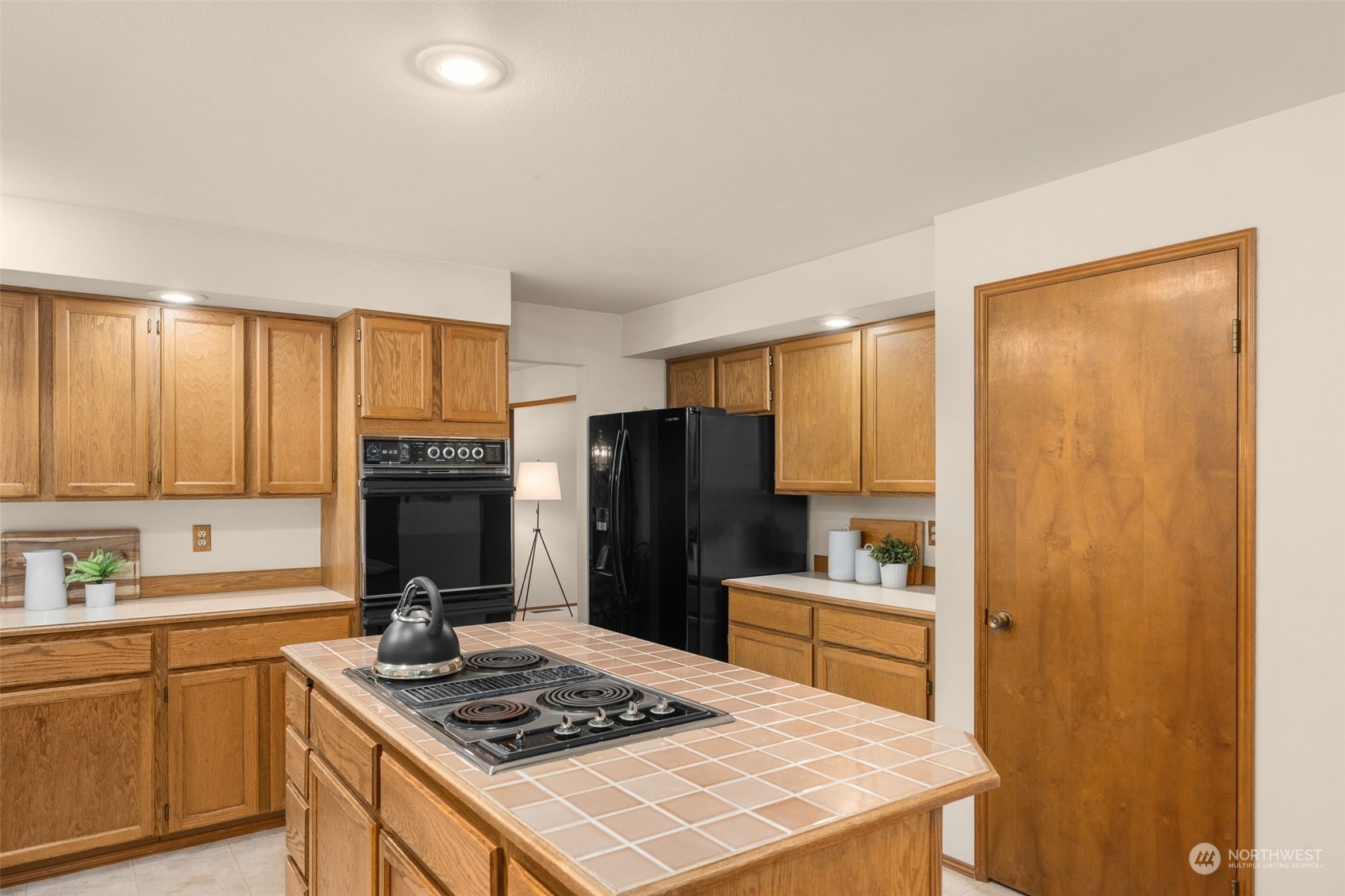 15518 Southeast 183rd Drive Renton, WA 98058 - Photo 14 of 35 a kitchen with a refrigerator a stove a sink and dishwasher with wooden floor