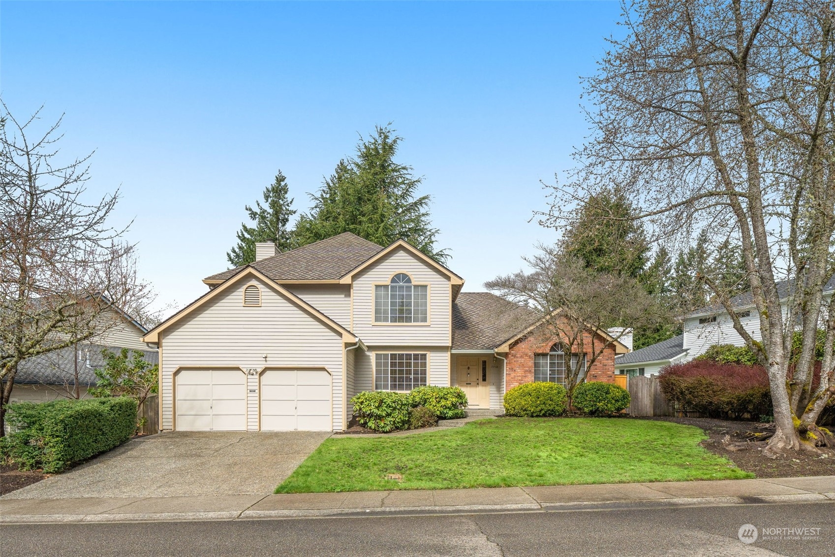 15518 Southeast 183rd Drive Renton, WA 98058 - Photo 2 of 35 a front view of a house with a garden and trees