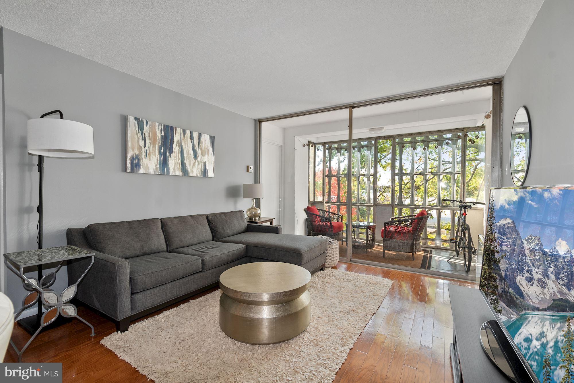 1311 Delaware Avenue Southwest, Unit S346 Washington, DC 20024 - Photo 3 of 23 a living room with furniture and a large window