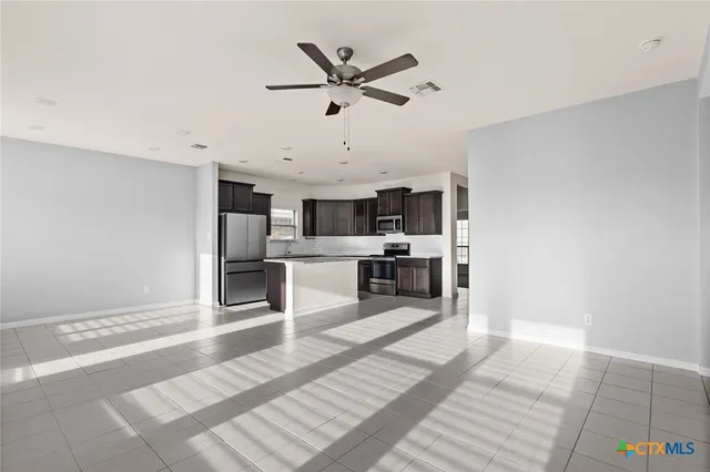 a living room with kitchen island furniture and a kitchen view