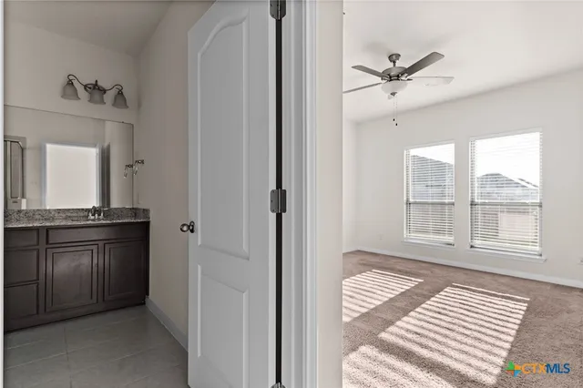 a view of a hallway to a livingroom with wooden floor and a cabinet