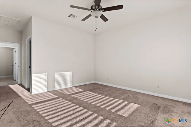 a view of a bedroom with a bed and wooden floor