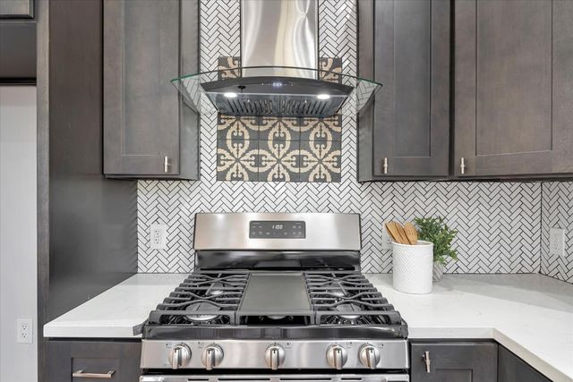 a stove top oven sitting inside of a kitchen