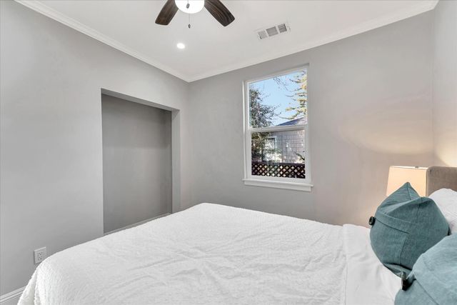 a bedroom with a large bed and a chandelier