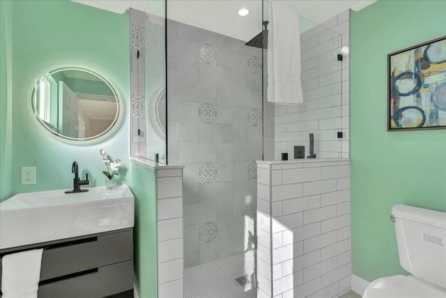 a bathroom with a sink a toilet and a mirror