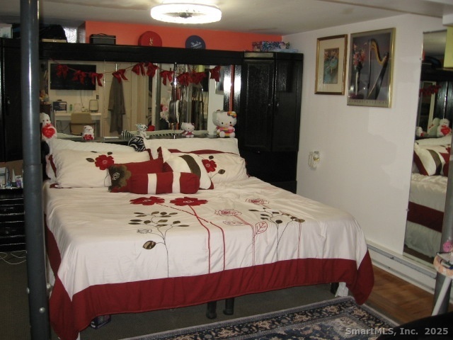 105 Edin Avenue Waterbury, CT 06706 - Photo 19 of 27 a bedroom with a bed and glass window