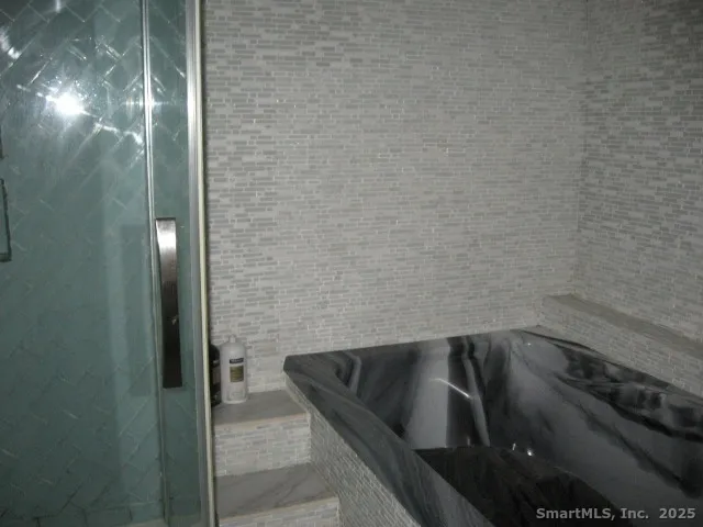 a bed sitting in a bedroom next to a lamp