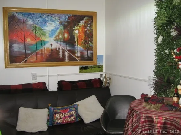 a bed sitting in a bedroom next to a lamp
