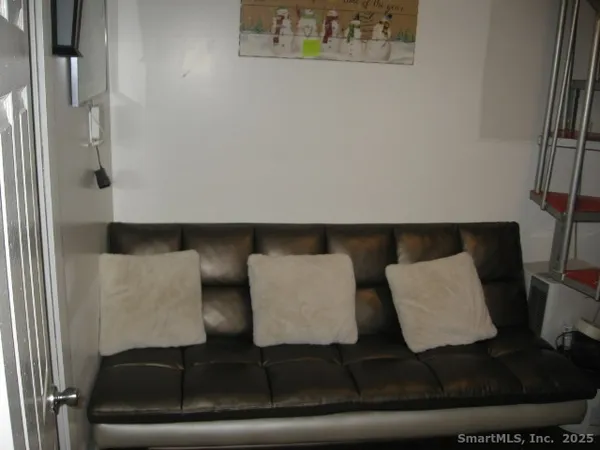 a bedroom with a bed and a chair
