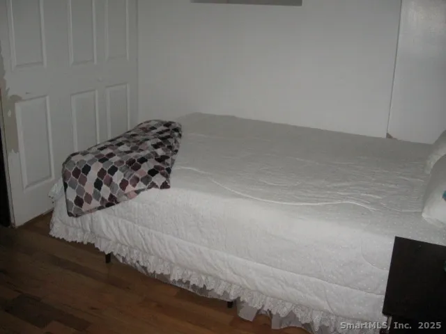 a view of a closet with wooden floor