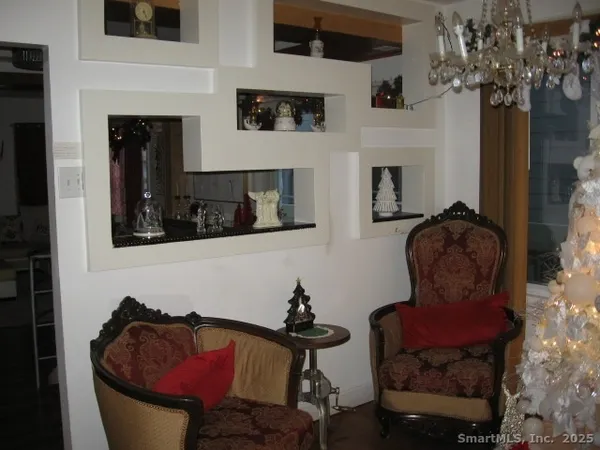 a kitchen with stainless steel appliances granite countertop white cabinets and a potted plant
