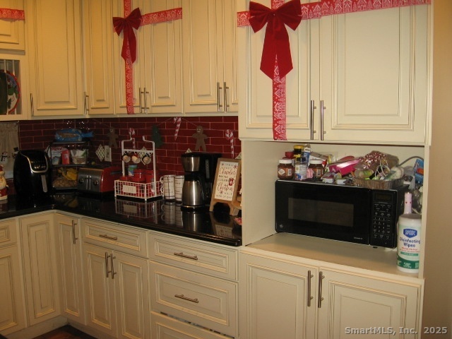 105 Edin Avenue Waterbury, CT 06706 - Photo 10 of 27 a kitchen with stainless steel appliances granite countertop white cabinets and a potted plant