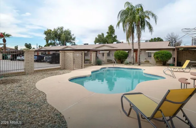 a view of a backyard with a patio and fire pit