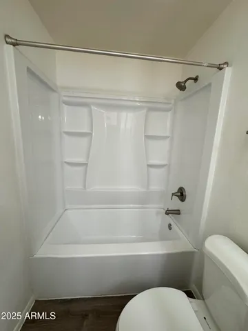 a bathroom with a toilet and a bathtub