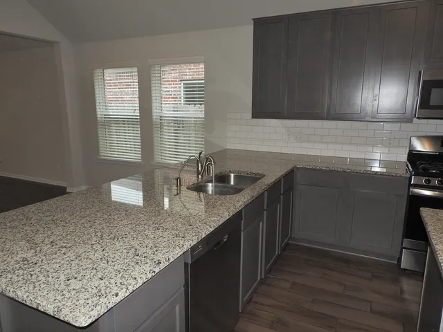 a kitchen with a sink and cabinets