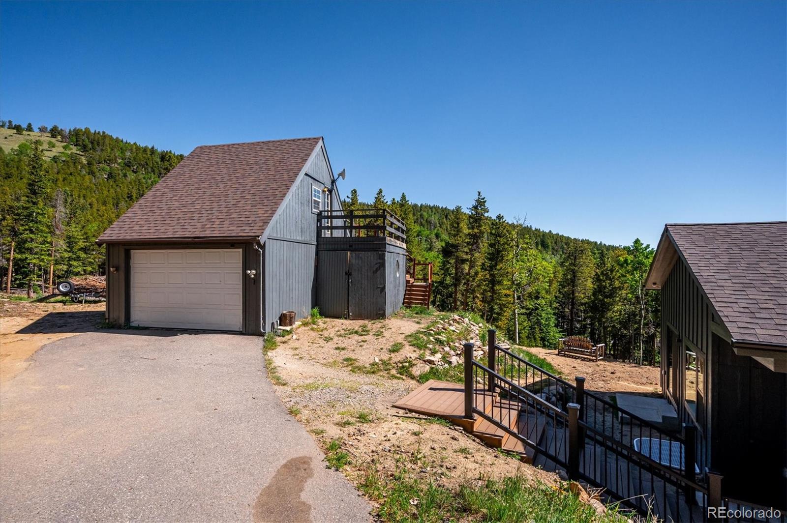 1633 Sinton Road Evergreen, CO 80439 - Photo 43 of 50 a view of house with backyard and seating space