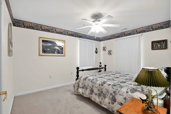 a bedroom with a bed and a ceiling fan