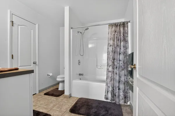 a bathroom with a mirror a shower and a sink