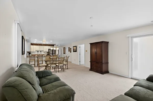 a living room with furniture and a dining table