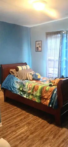 a bed sitting in a bedroom next to a window